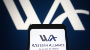 In this photo illustration Western Alliance Bancorporation (WAL) logo is seen on a mobile phone and a computer screen.
