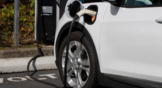 GM Chevy Bolt EV electric car is seen charging at a Volta Charging Station in a parking lot. EV stocks