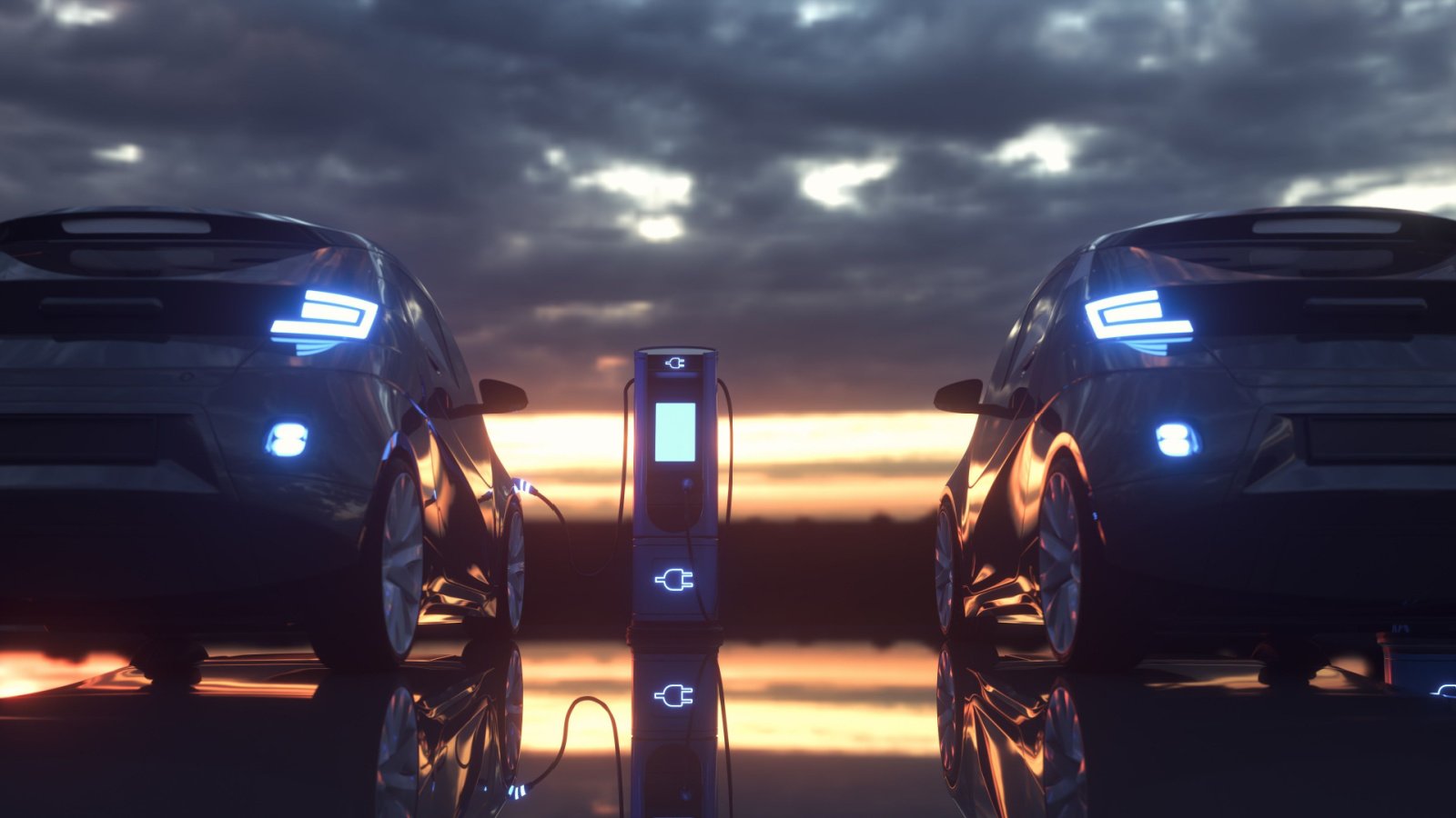 Two electric vehicles facing a dark sky, sunset background with one EV hooked up to an EV charger in between the two cars