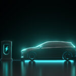 Electric car backlit by cyan blue neon light next to EV charger with cyan blue light and lightning bolt symbol, all against a black background. ev stocks to buy