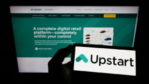 Person holding smartphone with logo of U.S. fintech company Upstart Network Inc. (UPST) on screen in front of website. Focus on phone display. Unmodified photo.