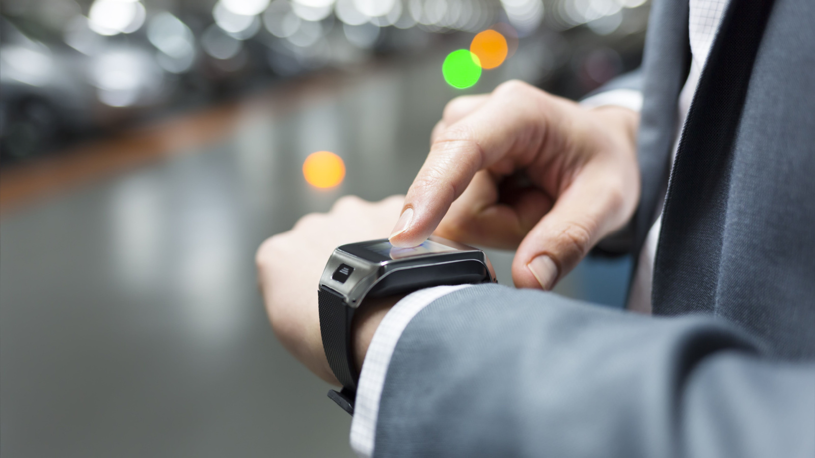 Man in suit wearing tech watch representing Wearable Devices (WLDS) stock