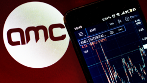 In this photo illustration the stock market information of AMC Entertainment Holdings, Inc. displays on a smartphone while the logo of AMC Entertainment Holdings, Inc