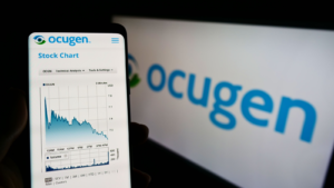 Person holding cellphone with webpage of US biopharmaceutical company Ocugen Inc (OCGN) on screen in front of logo Focus on center of phone display