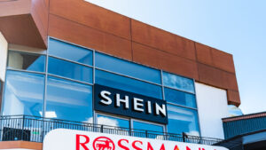 A Shein sign on the window of a large corporate building.