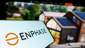 A smartphone with the logo of the American company Enphase Energy Inc. (ENPH) on the screen in front of a business website. Focus on the left side of the phone display. Uncensored photo.