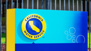 An image of a blue and light blue rectangle sign with the "California Water Service" yellow and blue logo on a lawn.