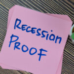 The words "recession proof" written on a pink sticky note. bulletproof stocks