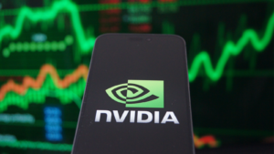 Nvidia Corporation (NVDA) logo displayed on smartphone with stock chart background.  Nvidia is a global leader in artificial intelligence hardware.