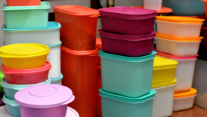 Pile of several and many Tupperware plastic products, Tupperware Corporation, (TUP) an American multinational company produces plastic food storage containers and bottles