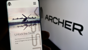 Person holding mobile phone with web page of US eVTOL aircraft company Archer Aviation Inc. (ACHR) on screen with logo. Focus on center of phone display. Unmodified photo.