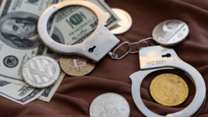 Bitcoins and handcuffs as an abstract symbol of crime that can hide a crypto currency.