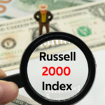 Russell 2000 Index. Magnifying glass showing the words. Background of banknotes and coins. Basic concepts of finance. Business theme. Financial terms.