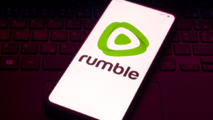 In this photo illustration the Rumble logo seen displayed on a smartphone. RUM stock