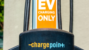 Selective focus. Detail of ChargePoint commercial EV electric vehicle charging station on uncovered parking lot. CHPT stock
