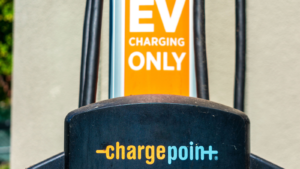 Selective focus.  Detail of a ChargePoint commercial electric vehicle charging station in an outdoor parking lot.  CHPT shares