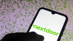 In this photo illustration the Nextdoor logo seen displayed on a smartphone. KIND stock