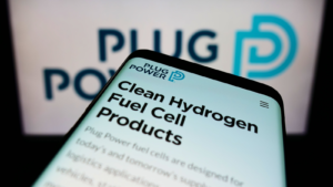 Mobile phone with webpage of American hydrogen fuel cell company Plug Power Inc (PLUG) on screen in front of logo Focus on top-left of phone display