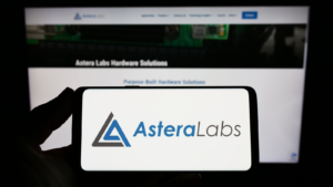 Person holding smartphone with logo of U.S. semiconductor company Astera Labs Inc. (ALAB) on screen in front of website. Focus on phone display. Unmodified photo.