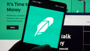 Robinhood (HOOD) app and logo on screen. Robinhood financial services company. The company offers mobile app and website that offers people the ability to invest in stocks