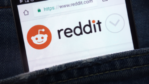Reddit (RDDT) website displayed on smartphone hidden in jeans pocket