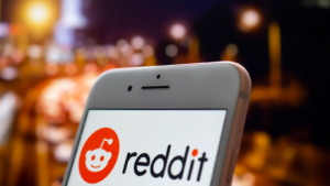 An iPhone Plus with a Reddit (RDDT) logo on the screen. Reddit IPO