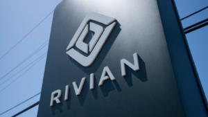 Rivian (RIVN) logo is seen at a Rivian service center in South San Francisco, California. Rivian Automotive, Inc. is an electric vehicle automaker.