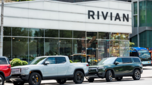 The front of a Rivian (RIVN) storefront is seen lined up with Rivian R1T and R1S model trucks out in front.