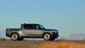 An all electric Rivian (RIVN) R1T pickup truck driving through the American soutwest desert on the I-10 freeway towards Tucson.