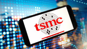 The logo of TSMC Taiwan Semiconductor Manufacturing Company (TSM) is displayed on the mobile phone screen