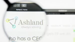 A magnifying glass zooms in on the website for Ashland (ASH). 