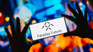 In this photo illustration, the Faraday Future logo is displayed on a smartphone screen. FFIR stock