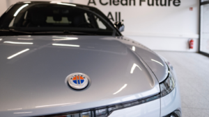 new grey electric Fisker Ocean in showroom, Dual Motor AWD, trends EV Europe, technological advancements automotive industry, environmental cleanliness vehicle. Fisker stock