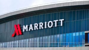 The front of a Marriott (MAR) building featuring the company name and logo. 