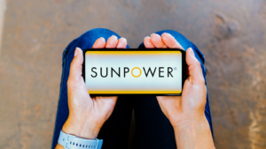 In this photo illustration, the SunPower Corporation logo is displayed on a smartphone screen. SPWR stock