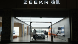 facade of ZEEKR electric car store with customer. Chinese EV brand owned by Geely. ZK stock