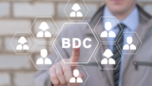 Businessman using virtual touch screen presses abbreviation: BDC. Concept of BDC Business Development Company.