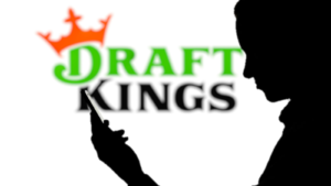 DraftKings logo with silhouette of man using smartphone. is an American daily fantasy sports contest and sports betting company. DKNG stock