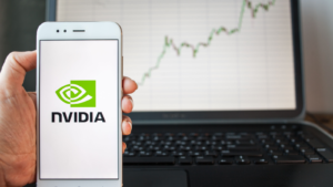 Nvidia Corporation logo on smartphone screen. Against stock prices, stock chart. Investments in securities.. NVDA stock