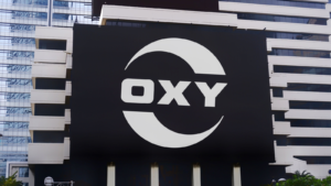 Occidental Petroleum Corporation (Oxy) logo seen on billboard.is an American company engaged in hydrocarbon exploration in the United States, and the Middle East. OXY stock
