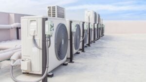 A row of air conditioning units lined up on the roof.