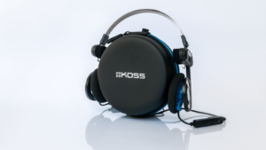 Koss Porta Pro Wireless headphones on a round case like on your head on a white background with reflection