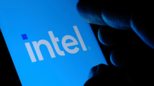 New Intel logo seen on the screen and blurred fingertip touching it in a dark. Intel presented its rebranded logotype on September 2nd 2020. Selective focus. INTC stock