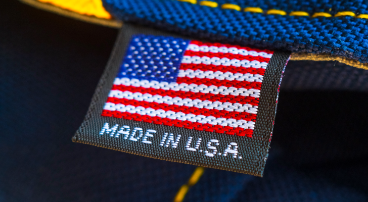 An image of a tag on fabric that says' Made in U.S.A.' to represent reshoring and automation; reshoring stocks