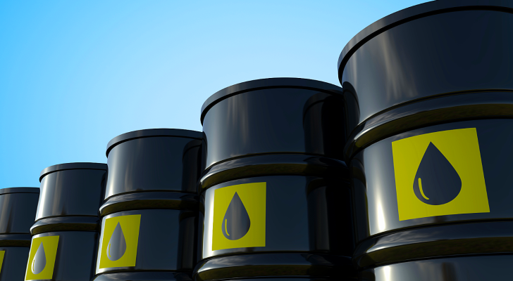 An image of black crude oil barrels lined up in a row, rising in height like a rising bar graph, to represent today's oil trade, oil volatility